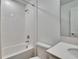 Bathroom showcasing a white tiled shower-tub, toilet, vanity with quartz countertops, and modern fixtures at 272 Pershing St, Bartow, FL 33830