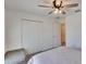 Bright bedroom with a ceiling fan, plush carpet, and a view of a closet and door at 272 Pershing St, Bartow, FL 33830
