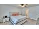 Well-lit bedroom with a ceiling fan, a comfortable queen-size bed, and neutral decor at 272 Pershing St, Bartow, FL 33830