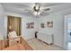 Charming Bedroom with a crib, dresser, accent chair, decor, and ceiling fan offers a cozy space at 272 Pershing St, Bartow, FL 33830