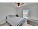 Cozy bedroom featuring a simple black metal bed frame, a window with blinds, and a gray storage bench at 272 Pershing St, Bartow, FL 33830