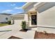 Inviting front entrance featuring a dark green door, wreath, and well-maintained landscaping at 272 Pershing St, Bartow, FL 33830