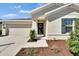 Inviting front entrance with a wreath on the door and manicured landscaping leading to a covered doorway at 272 Pershing St, Bartow, FL 33830