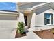 Inviting front entrance with a wreath on the door, complemented by lush landscaping and a covered entryway at 272 Pershing St, Bartow, FL 33830