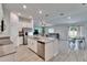 Open-concept kitchen with stainless steel appliances, a center island, and a view of the living and dining areas at 272 Pershing St, Bartow, FL 33830