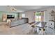 Inviting living room with wood-look tile flooring, comfortable seating, and natural light from sliding doors at 272 Pershing St, Bartow, FL 33830