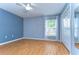 Light bedroom features wood floors, closet, and large window at 3518 Remington Oaks Way, Lakeland, FL 33810