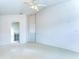 Spacious bedroom with neutral carpet, ceiling fan, and attached bathroom at 3518 Remington Oaks Way, Lakeland, FL 33810
