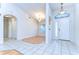 Bright entryway featuring neutral tile flooring, arched doorway, chandelier, and a window above the front door at 3518 Remington Oaks Way, Lakeland, FL 33810