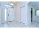 Entryway with tile flooring, closet, overhead lighting, and a sidelight window by the front door at 3518 Remington Oaks Way, Lakeland, FL 33810