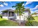 Exterior backyard view with fruit tree near lanai and well kept lawn and landscaping at 3518 Remington Oaks Way, Lakeland, FL 33810