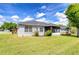 Exterior side view of home showing screened in porch, well maintained lawn and landscaping at 3518 Remington Oaks Way, Lakeland, FL 33810