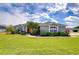 Well maintained single story home with a manicured front lawn and lush landscaping at 3518 Remington Oaks Way, Lakeland, FL 33810