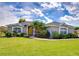 Charming one-story home with a well-manicured lawn, mature trees and inviting yellow front door at 3518 Remington Oaks Way, Lakeland, FL 33810
