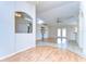 Inviting living room featuring wood and tile flooring, vaulted ceilings, and French doors at 3518 Remington Oaks Way, Lakeland, FL 33810