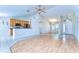 Bright living room boasts a ceiling fan, vaulted ceiling, and an open plan to the kitchen at 3518 Remington Oaks Way, Lakeland, FL 33810