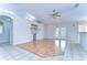 Bright living area with wood floors, built-in shelves, ceiling fan, and French doors leading outside at 3518 Remington Oaks Way, Lakeland, FL 33810