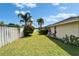 Serene backyard featuring lush greenery, a well-maintained lawn, and privacy fencing at 7402 Gunstock Dr, Lakeland, FL 33809