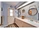 Charming bathroom featuring double sinks, modern fixtures, and unique decorative elements at 7402 Gunstock Dr, Lakeland, FL 33809