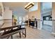 Open-concept dining area with a modern table, stylish lighting, and seamless flow to the living spaces at 7402 Gunstock Dr, Lakeland, FL 33809