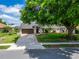 Charming home exterior featuring a well-manicured lawn, mature trees, and an inviting entrance at 7402 Gunstock Dr, Lakeland, FL 33809
