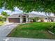 Charming home with a well-manicured lawn, two car garage, and a welcoming front entrance at 7402 Gunstock Dr, Lakeland, FL 33809