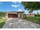 Charming single-story home features a well-manicured lawn, a two car garage, and a classic tan exterior at 7402 Gunstock Dr, Lakeland, FL 33809