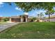 Charming single-story home with a well-manicured front lawn, mature trees, and an attached two-car garage at 7402 Gunstock Dr, Lakeland, FL 33809