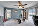 Well-lit home gym features exercise equipment, neutral walls, and sliding door access at 7402 Gunstock Dr, Lakeland, FL 33809