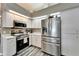 Kitchen with stainless steel refrigerator, oven, and microwave at 7402 Gunstock Dr, Lakeland, FL 33809