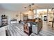 Open concept living room featuring gray flooring and a comfortable, large sectional sofa at 7402 Gunstock Dr, Lakeland, FL 33809