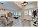 Bright and airy living room with hardwood floors, large windows, and neutral decor at 7402 Gunstock Dr, Lakeland, FL 33809