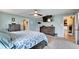 Large main bedroom with blue walls, wood furniture, a ceiling fan, and an ensuite bathroom at 7402 Gunstock Dr, Lakeland, FL 33809
