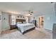 Primary bedroom with large bed, ceiling fan, and ample natural light at 7402 Gunstock Dr, Lakeland, FL 33809
