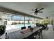 Spacious covered patio with large dining table and ample seating overlooking the pool at 7402 Gunstock Dr, Lakeland, FL 33809