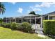 View of a screened-in pool area surrounded by lush greenery, providing a private and relaxing outdoor space at 7402 Gunstock Dr, Lakeland, FL 33809