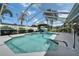 Inviting screened-in pool with clear blue water, poolside seating, and a well-maintained patio area at 7402 Gunstock Dr, Lakeland, FL 33809
