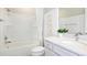 Bright bathroom with a shower-tub combo, white vanity, and modern fixtures at 8953 Wildlight Trl, Wildwood, FL 34785