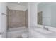 Bathroom with a shower-tub combo, tiled walls, sink, and vanity at 8953 Wildlight Trl, Wildwood, FL 34785