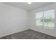 This bedroom has plush carpeting, neutral walls, a window with blinds, and natural light at 8953 Wildlight Trl, Wildwood, FL 34785