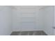 Walk-in closet with wire shelving and neutral carpet at 8953 Wildlight Trl, Wildwood, FL 34785