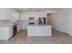 Beautiful kitchen with stainless steel appliances, a large island, and bright white cabinetry at 8953 Wildlight Trl, Wildwood, FL 34785