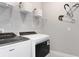 Functional laundry room featuring front-load machines, wire shelving, and decorative accents at 8953 Wildlight Trl, Wildwood, FL 34785
