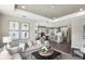 Open-concept living room with modern furnishings, gray sofa and decor, connected to kitchen at 8953 Wildlight Trl, Wildwood, FL 34785