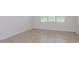 Open room with tile floors and a window that brings in natural light at 8953 Wildlight Trl, Wildwood, FL 34785