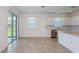 Open-concept space featuring tile floors, plenty of natural light, and access to the kitchen at 8953 Wildlight Trl, Wildwood, FL 34785
