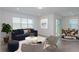 Open-concept living room featuring tile flooring, a large window, and neutral paint at 8953 Wildlight Trl, Wildwood, FL 34785