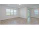 Inviting living area with tile floors and a sliding glass door that fills the room with natural light at 8953 Wildlight Trl, Wildwood, FL 34785