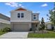 Charming two-story home featuring a 2 car garage, landscaped yard, and stylish architectural details at 1768 Frogmore Ave, Haines City, FL 33844