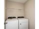 Convenient laundry room equipped with a new washer, dryer, and wire shelf at 1768 Frogmore Ave, Haines City, FL 33844